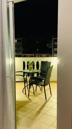 a table and chairs on a balcony at night at Downtown Studio 41 in Serres