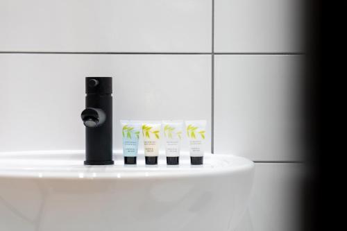 a group of four toothbrushes on a shelf in a bathroom at Home @ Arkles Lane in Liverpool