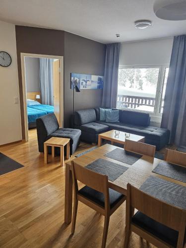 a living room with a couch and a table at Ruka Chalets Ski-In 1313 in Ruka