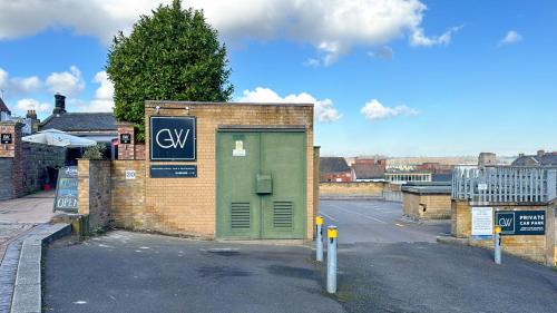 a brick building with a green door on a street at The George Wright Boutique Hotel, Bar & Restaurant in Rotherham