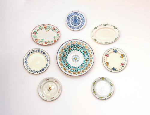 a group of plates sitting on a wall at Lake view 14 in Pisogne