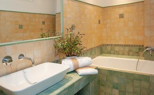 a bathroom with a sink and a bath tub at Lake view 14 in Pisogne