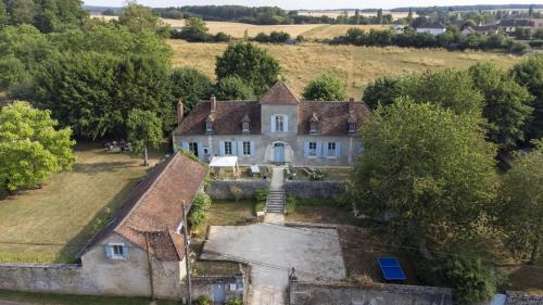 an aerial view of an old house in a field at La Cuvellerie in Narcy