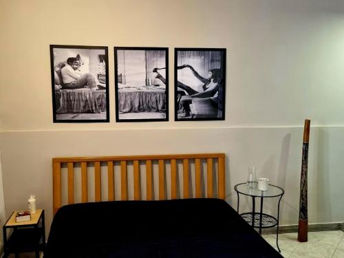 ein Schlafzimmer mit vier Bildern an der Wand in der Unterkunft Civico 3 - Napoli in Neapel
