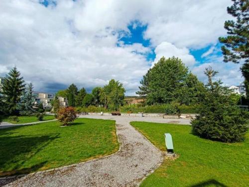 a park with a bench in the grass at Le Studio 44 in Han-sur-Lesse