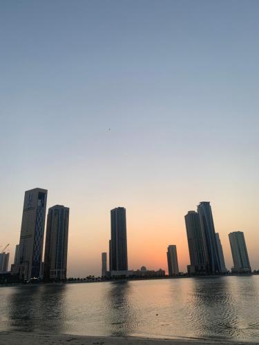 a skyline of a city with tall buildings at Studio Apartment in Sharjah