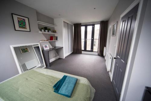 a bedroom with a bed and a hallway with a window at Fabulous Camberwell Home Z2 in London