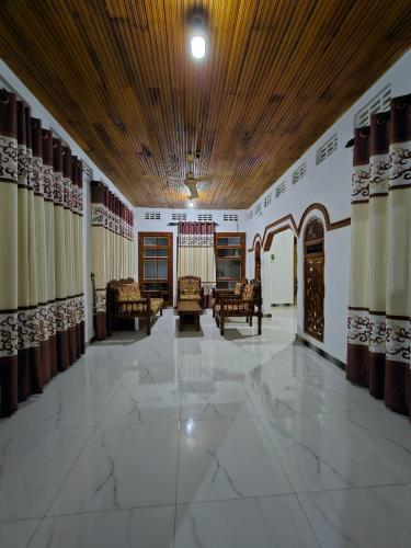 a large room with chairs and a wooden ceiling at SSM GUEST INN in Trincomalee