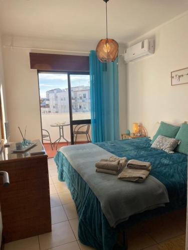 a bedroom with a bed with towels on it at Olimar Sea View Apartment in Albufeira