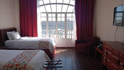 a hotel room with two beds and a window at Best Western Majestic in Mexico City