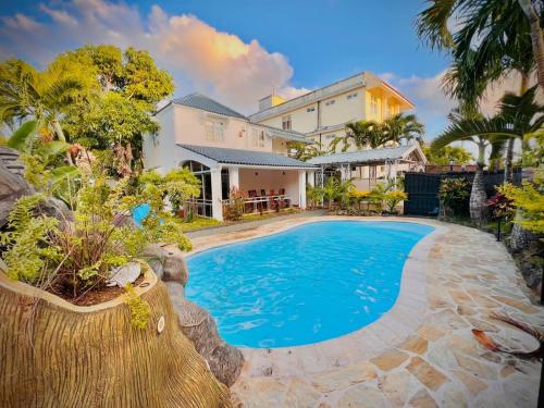 an image of a swimming pool in front of a house at N.Caunhye Villa in Pereybere