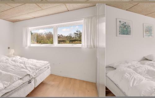 a white bedroom with two beds and a window at 3 Bedroom Nice Home In Sams in Nordby