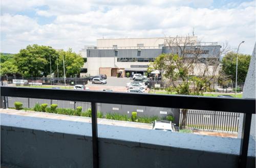a view of a parking lot from a balcony at The Bolton Rosebank Apartment 26 in Johannesburg