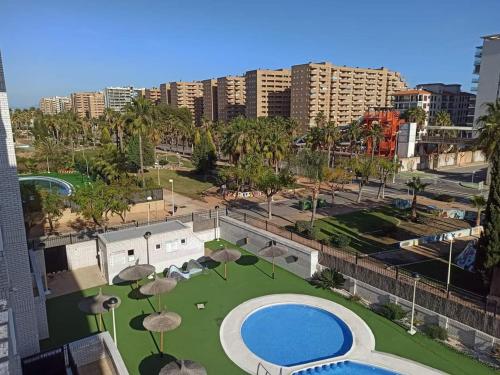 a view of a park with a pool and umbrellas at Apartamento en Magic World. Nueva Marina Dor in Oropesa del Mar