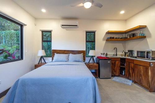 a bedroom with a large bed and a kitchen at Grande Espiritu 2 bedroom Casita, close to beach, 2 queen beds in Refundores