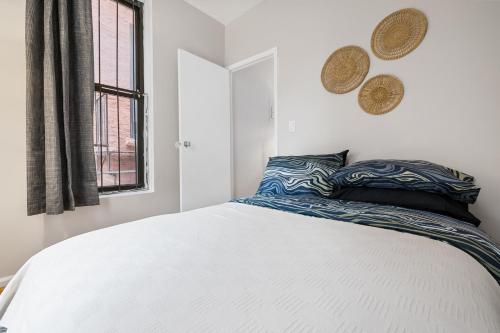 a bedroom with a large white bed and a window at Experience the heart of Times Square in New York