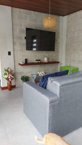 a living room with a couch and a flat screen tv at Casas Plamont in Fortuna