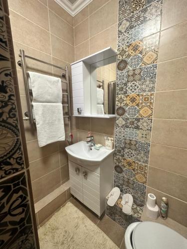 a small bathroom with a sink and a mirror at "Гостевой дом Анны" по улице Абая, 165 in Taldykorgan