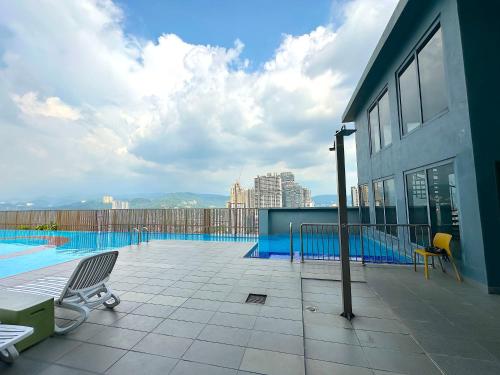 a balcony with a swimming pool on top of a building at 3 Towers Jalan Ampang By Serenity Vacation Homes in Kuala Lumpur