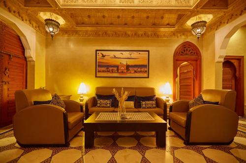 a living room with couches and a coffee table at Villa Taj Sofia & Spa in Marrakech