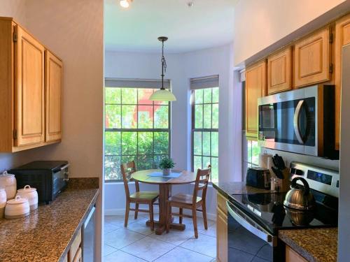 a kitchen with a table and a dining room at Sun City Grand Oasis: Luxury Condo Living in La Solana in Surprise