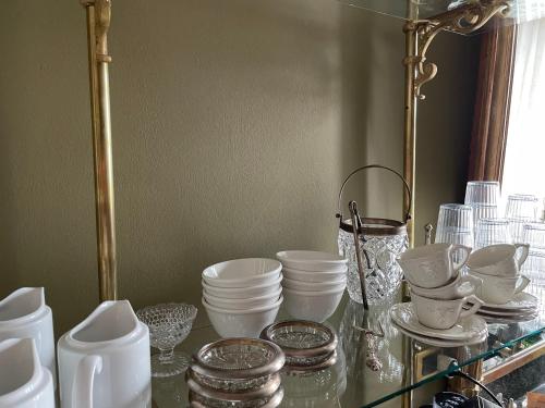 a glass table with a bunch of dishes on it at B&B Colombo by Addler House Ospitality in Mestre