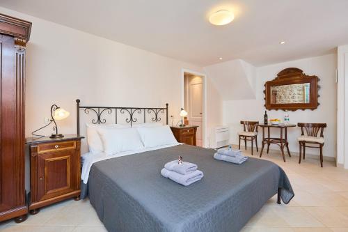 a bedroom with a bed with two towels on it at Doria Apartments in Dubrovnik