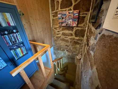 a staircase with a blue door and a book shelf at Casa da Eira 