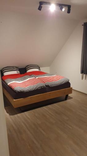 a bedroom with a bed in a room with a ceiling at Fewo RoBBe in Wangerland
