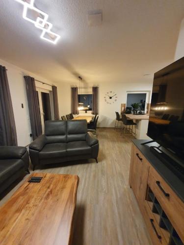 a living room with a couch and a table at Fewo RoBBe in Wangerland
