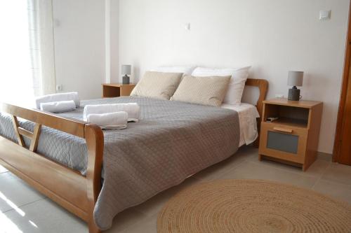 ein Schlafzimmer mit einem Bett und einem Nachttisch in der Unterkunft Loupino Couples Romance in Stoupa