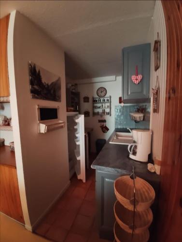 une cuisine avec des armoires bleues et un comptoir dans l'établissement Superbe appartement à Orcières merlette, à Orcières