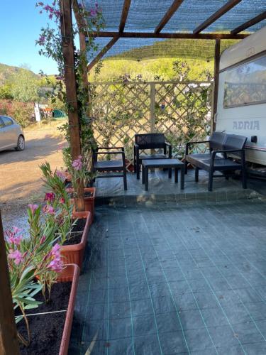 a group of benches sitting on a patio at S'Abba Druche rooms in Bosa