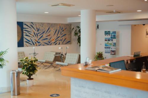 an office with a reception desk and a table at Hotel Grotta Di Tiberio in Sperlonga