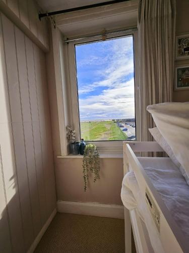 a bedroom with a window with a view of a field at Seaview 2 bedroom apartment in Littlehampton