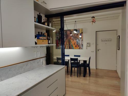 a kitchen and dining room with a table and chairs at Cozy Apartment Brera in Milan