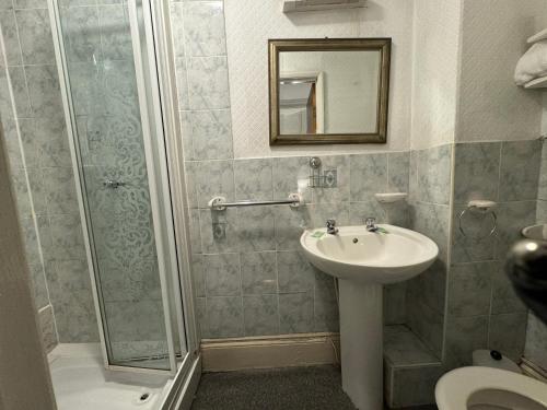 a bathroom with a sink and a shower at Hotels 24-7 - The Old Knoll Guesthouse in Newport
