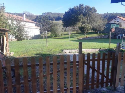 a wooden fence in front of a green field at Casa Pasiega in Renedo de Piélagos