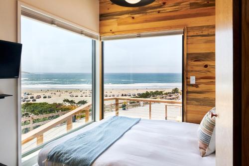 a bedroom with a bed and a view of the beach at Dillon Beach Resort in Dillon Beach