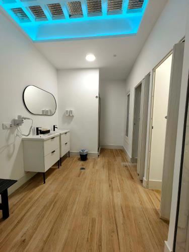 a bathroom with a sink and a mirror on the ceiling at Hostel Siesta & Go (Atocha) in Madrid