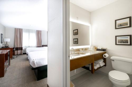 a hotel bathroom with a sink and a bed at Comfort Inn Great Falls South in Great Falls