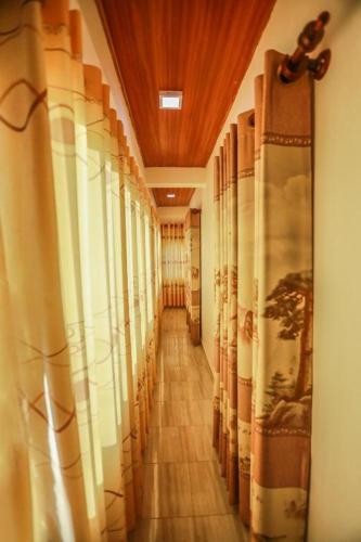a long hallway with curtains in a building at Silverin Rest Apartment in Panadura