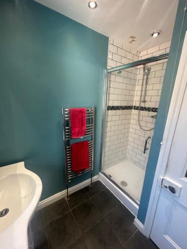 a bathroom with a shower and a toilet and a sink at Mill Hill Stays in Derby