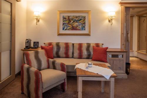 a living room with a couch and a table at Superior Hotel Post Ischgl in Ischgl