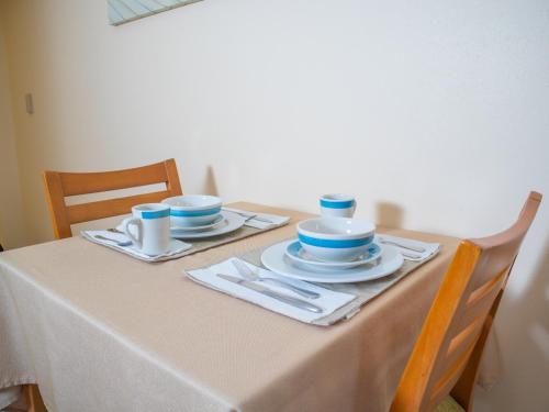 a table with blue and white dishes on it at Princess Vegas Hotel & Casino in Corozal