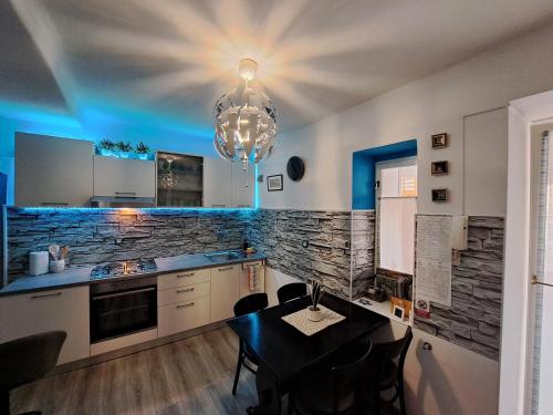 a kitchen with a dining table and a chandelier at Apartman Darija in Pazin