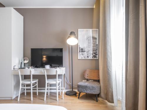 a living room with a table and chairs and a desk at Dome in Cagliari