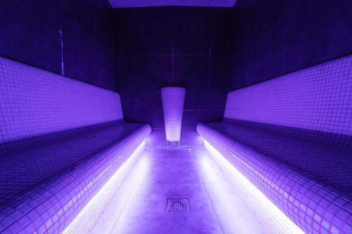 a purple tunnel with a row of lights at Penzión Aqua Maria in Veľaty