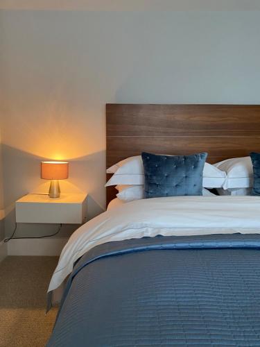 a bedroom with a large bed with a wooden headboard at Belgravia Apartments in London