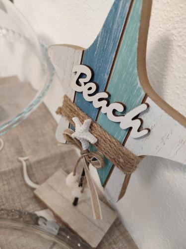 a wooden cross with the word peace on it at Il Sogno di Giò in Alghero